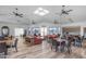 A spacious community room with tables, chairs and couches at 10377 W Yukon Dr, Peoria, AZ 85382