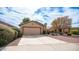 Charming single-story home with a large driveway, desert landscaping, and a well-maintained facade at 10377 W Yukon Dr, Peoria, AZ 85382