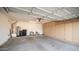 Spacious garage featuring ample built-in storage cabinets and concrete flooring at 10377 W Yukon Dr, Peoria, AZ 85382