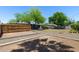 Large, fenced backyard with mature trees and potential for landscaping at 105 E Hermosa Dr, Tempe, AZ 85282