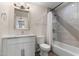 Bright bathroom featuring a shower-tub combo, contemporary fixtures, and stylish vanity at 105 E Hermosa Dr, Tempe, AZ 85282