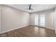 A clean, empty bedroom with wood-look floors and French doors at 105 E Hermosa Dr, Tempe, AZ 85282