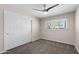 Cozy bedroom with a ceiling fan, plush carpeting, and a large window offering natural light at 105 E Hermosa Dr, Tempe, AZ 85282