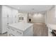 Bright, open kitchen with island seating and stainless steel appliances, flowing into the cozy living room at 105 E Hermosa Dr, Tempe, AZ 85282