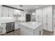 Stylish white kitchen with stainless steel appliances and a center island perfect for entertaining at 105 E Hermosa Dr, Tempe, AZ 85282