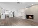 Open-concept living room with wood-look floors, an electric fireplace, and a modern kitchen at 105 E Hermosa Dr, Tempe, AZ 85282