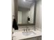 Modern half-bathroom with a framed mirror, sleek sink, and a cabinet for storage at 1055 N 86Th Pl, Scottsdale, AZ 85257
