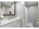 Bathroom features a modern sink, a shower with a white curtain, and bright lighting at 1055 N 86Th Pl, Scottsdale, AZ 85257