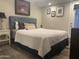 Cozy bedroom featuring decorative wall art, a spacious bed, and ample lighting at 1055 N 86Th Pl, Scottsdale, AZ 85257