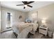 Cozy bedroom with ceiling fan, plush bedding, and access to outdoor space at 1055 N 86Th Pl, Scottsdale, AZ 85257