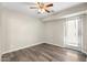 Spacious bedroom with wood-look floors, ceiling fan, and natural light, ready for personalization at 1055 N 86Th Pl, Scottsdale, AZ 85257