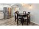Bright dining area with stainless steel refrigerator, wood-look flooring, and stylish lighting at 1055 N 86Th Pl, Scottsdale, AZ 85257