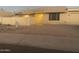 Charming single-story home with neutral toned exterior, a rock yard, and a quaint patio umbrella at 1055 N 86Th Pl, Scottsdale, AZ 85257
