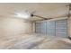 Empty garage with a gray sectional garage door at 1055 N 86Th Pl, Scottsdale, AZ 85257
