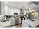 Bright kitchen with white cabinets, stainless steel appliances, and ample counter space at 1055 N 86Th Pl, Scottsdale, AZ 85257