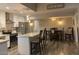 Bright kitchen with stainless appliances, white cabinets, and counter seating flows into dining area at 1055 N 86Th Pl, Scottsdale, AZ 85257