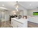 Kitchen with a view of the dining and living spaces and an island with pendant lighting at 1055 N 86Th Pl, Scottsdale, AZ 85257