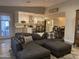 Open-concept living room and kitchen with a large gray sectional sofa at 1055 N 86Th Pl, Scottsdale, AZ 85257