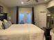 Beautiful bedroom with neutral decor, ample natural light, and access to a private outdoor area at 1055 N 86Th Pl, Scottsdale, AZ 85257