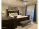 Charming main bedroom featuring a cozy bed, modern ceiling fan, and access to the outdoors at 1055 N 86Th Pl, Scottsdale, AZ 85257