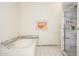 Clean bathroom featuring a tiled surround tub and a glass door shower, plus modern fixtures at 1124 E Rose Ln # 17, Phoenix, AZ 85014