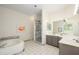 Bathroom boasting a soaking tub, tile surround shower, and dual sink vanity at 1124 E Rose Ln # 17, Phoenix, AZ 85014