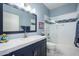 Beautiful blue bathroom with a white countertop vanity and a tub shower with glass doors at 1124 E Rose Ln # 17, Phoenix, AZ 85014
