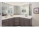 Bathroom featuring double sinks, vanity, and a large mirror with Hollywood style lighting at 1124 E Rose Ln # 17, Phoenix, AZ 85014