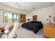 Bright bedroom featuring a large window, ceiling fan, and black colored bedding at 1124 E Rose Ln # 17, Phoenix, AZ 85014