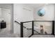 Upstairs hallway featuring modern railing and artwork at 1124 E Rose Ln # 17, Phoenix, AZ 85014