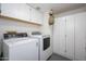 Laundry room featuring modern appliances, overhead cabinets, and storage at 1124 E Rose Ln # 17, Phoenix, AZ 85014