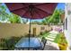 Private patio includes dining set, water feature, artificial turf, and colorful foliage at 1124 E Rose Ln # 17, Phoenix, AZ 85014