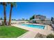 Community pool offers a refreshing escape with ample seating, a spa, and lush palm trees at 1124 E Rose Ln # 17, Phoenix, AZ 85014