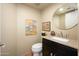 Well-lit powder room featuring granite countertop and decorative accents at 1124 E Rose Ln # 17, Phoenix, AZ 85014