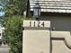 Street address of 1124 on a stone pillar with a light fixture at 1124 E Rose Ln # 17, Phoenix, AZ 85014
