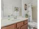 Bathroom featuring a wood vanity, white countertops, and shower with decorative curtain at 12417 W Apache St, Avondale, AZ 85323