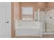 A relaxing bathroom area with a white bathtub and a glass walk-in shower at 12417 W Apache St, Avondale, AZ 85323