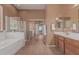 A spacious bathroom featuring a tiled floor, bathtub, and walk-in shower at 12417 W Apache St, Avondale, AZ 85323