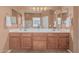 A spacious bathroom vanity includes double sinks, mirrors, and a decorative orchid at 12417 W Apache St, Avondale, AZ 85323