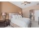 A comfortable bedroom features a ceiling fan, bedside lamps, and neutral decor at 12417 W Apache St, Avondale, AZ 85323