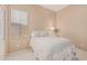 A cozy bedroom featuring a ceiling fan, a queen bed, and a window at 12417 W Apache St, Avondale, AZ 85323