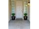 Inviting entryway with potted plants and a light fixture at 12417 W Apache St, Avondale, AZ 85323
