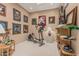Exercise room with an elliptical, decorative artwork, and wooden shelving at 12417 W Apache St, Avondale, AZ 85323