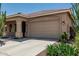 Spacious two-car garage with a concrete driveway and desert landscaping in front at 12417 W Apache St, Avondale, AZ 85323