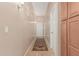 Hallway with tile flooring, neutral paint, and a decorative rug at 12417 W Apache St, Avondale, AZ 85323