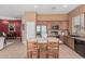 Open kitchen boasts an island with seating, wooden cabinets, and stainless steel appliances for modern living at 12417 W Apache St, Avondale, AZ 85323