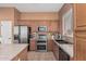 Updated kitchen equipped with stainless steel appliances, double ovens, and wood cabinets at 12417 W Apache St, Avondale, AZ 85323