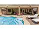 Backyard featuring a blue swimming pool with stairs to enter and a covered patio at 12417 W Apache St, Avondale, AZ 85323