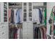 A walk-in closet features clothing racks, shelves, and pull-out drawers for optimal storage at 12417 W Apache St, Avondale, AZ 85323