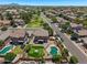 Aerial view of a residential area featuring a landscaped backyard with a putting green and pool at 1250 E Canyon Creek Dr, Gilbert, AZ 85295